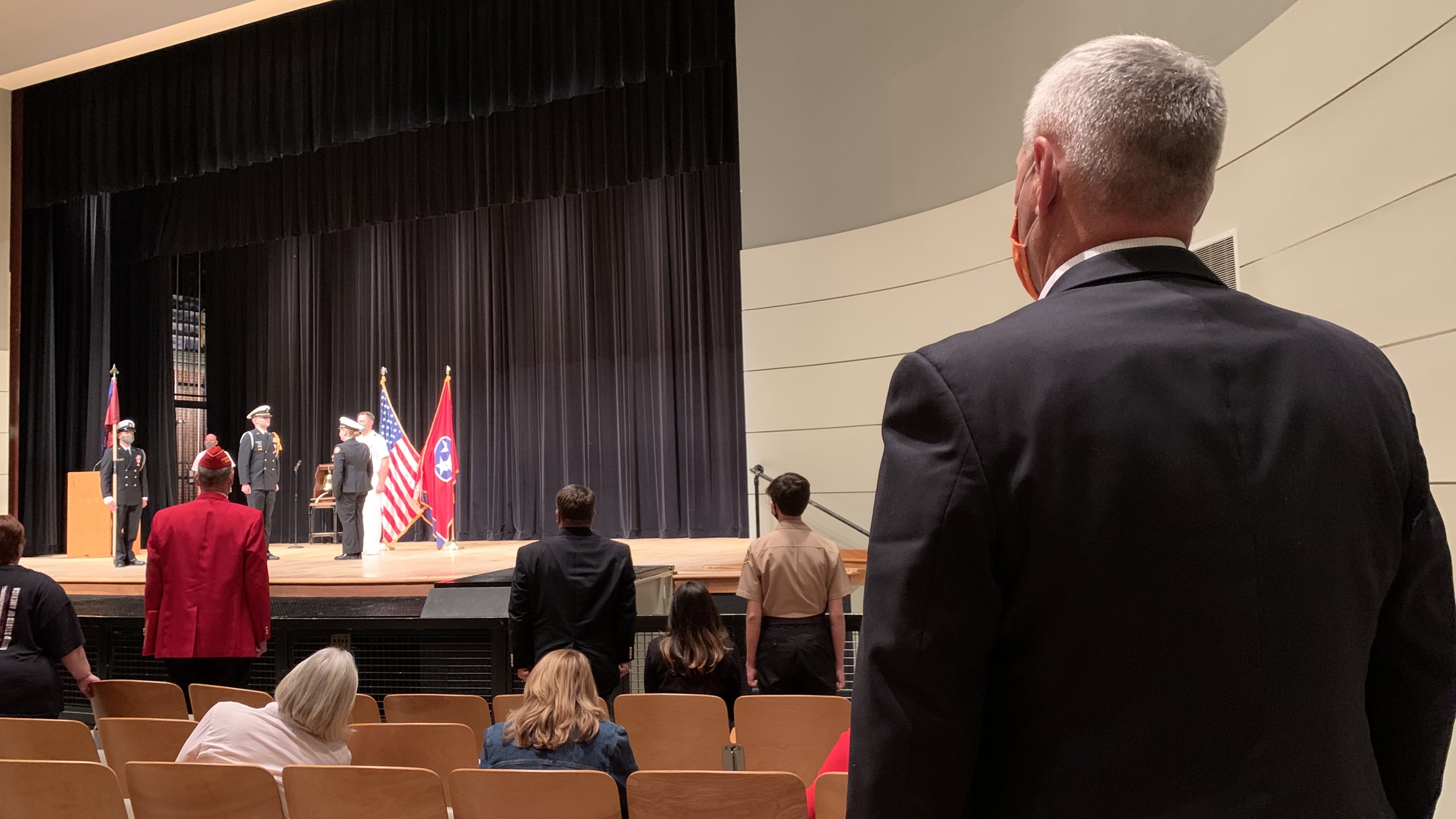 Veterans, cadets, and members of the military, including retired Capt. Gene Sievers at right, stood to recognize the change of command at the end of the evening’s ceremony.