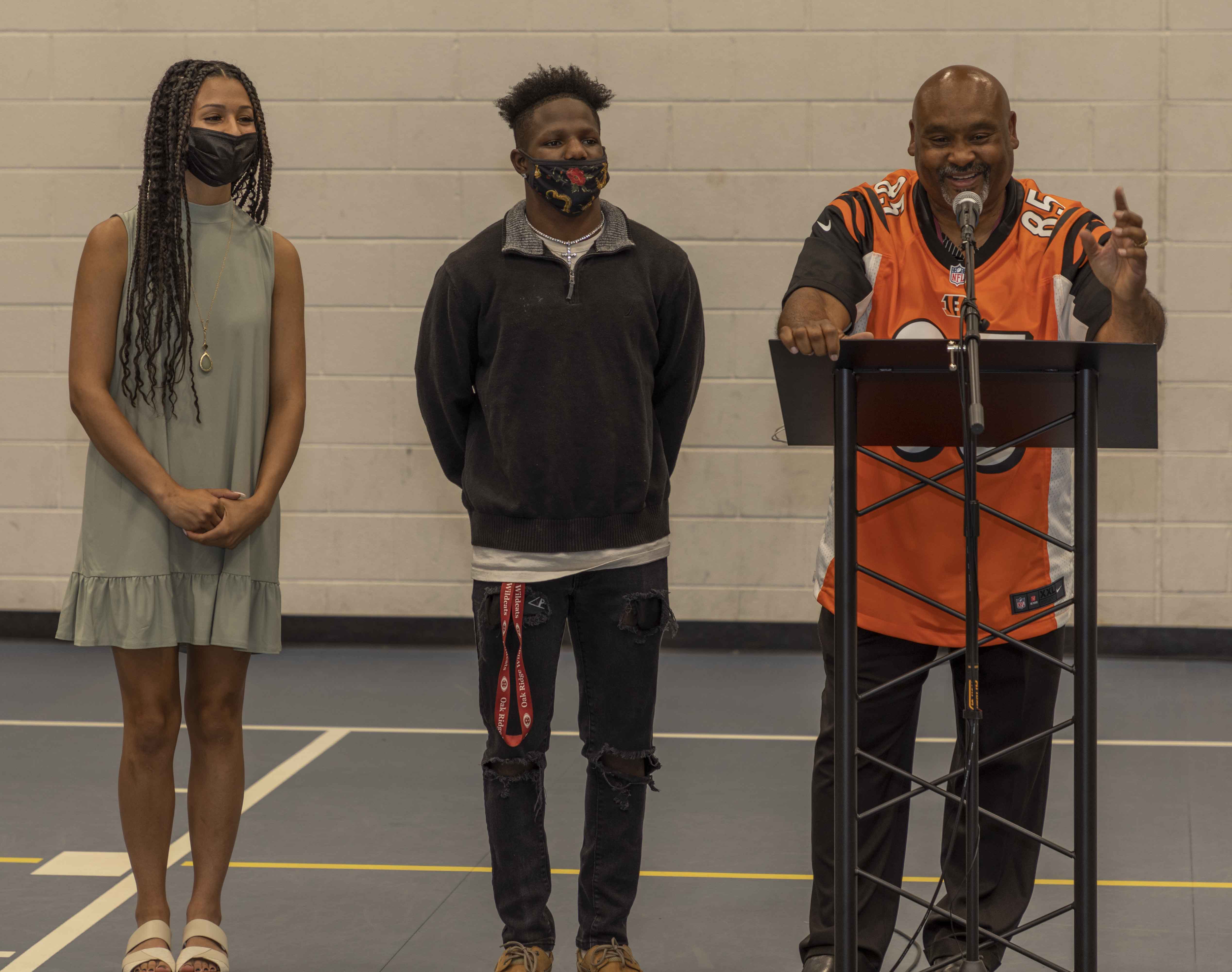 Scholarship recipients Faythe Summers and Jaylen Heyward listen as John Spratling of the Scarboro Alumni Association addresses the audience.