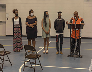 Scholarship recipients Maya Lewis, Bridget Slater, Faythe Summers, and Jaylen Heyward with John Spratling of the Scarboro Alumni Association during the ceremony at the Scarboro Community Center.