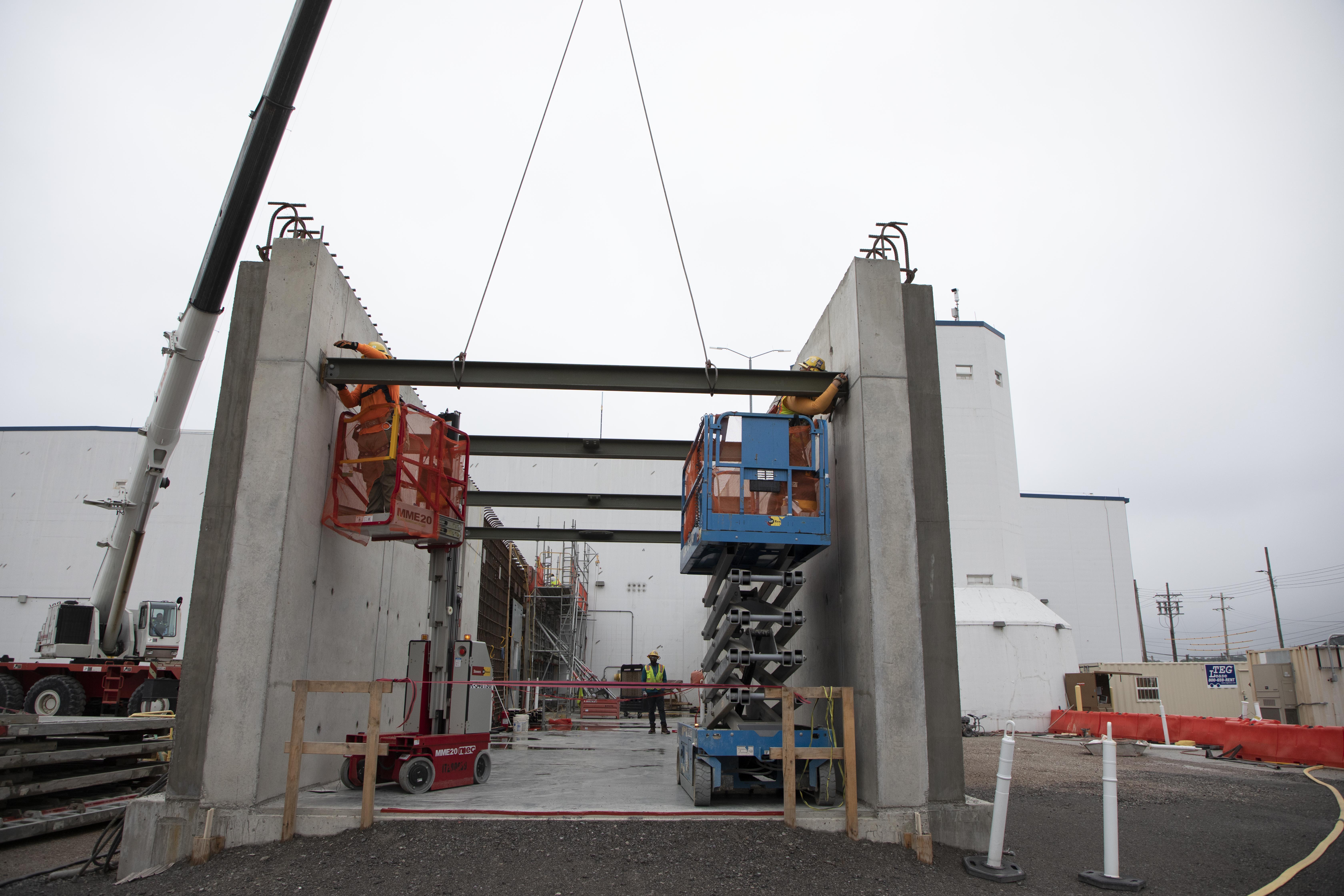 Ironworkers installing HEUMF Connector structural steel  
