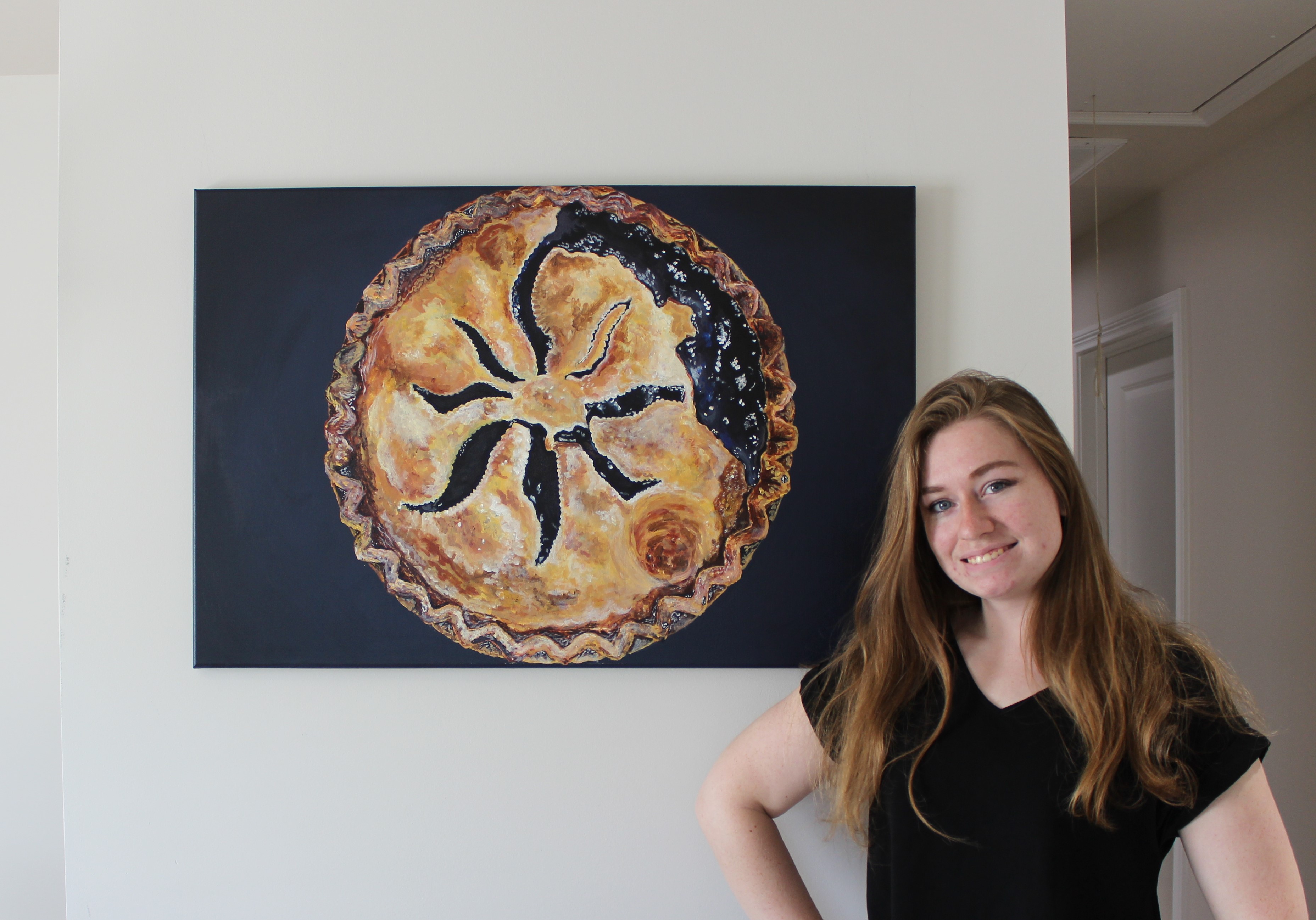 Y-12 Engineer Katie Romba, posing with one of her paintings