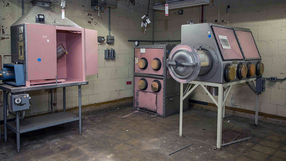 Pink fixative covers much of the abandoned equipment in Building 9206. The fixative is put on the equipment to encapsulate any remaining contamination.