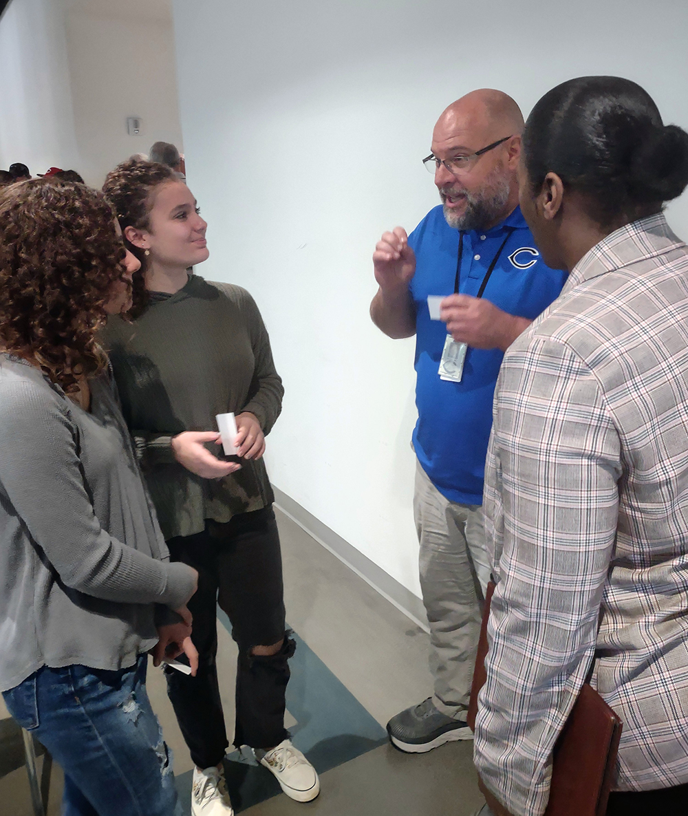 Clinton Middle School’s team meets with the representative from Eagle Bend Manufacturing to start planning their project.