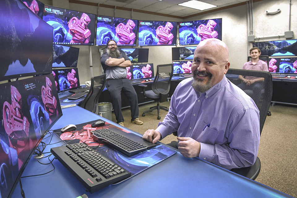 Personnel are shown in the NOC/SOC Control Room