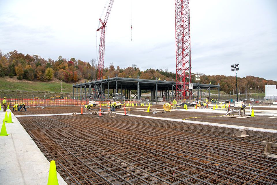UPF’s Mechanical Electrical Building, which will house most of the mechanical and electrical utility equipment required for UPF’s process facilities, rises behind rebar being placed for the Main Process Building.