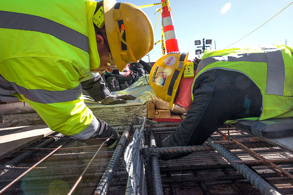 Workers place stay form between topper slabs on the Main Process Building (MPB) prior to concrete placement. MPB will be a 252,000-square-foot building with three levels.