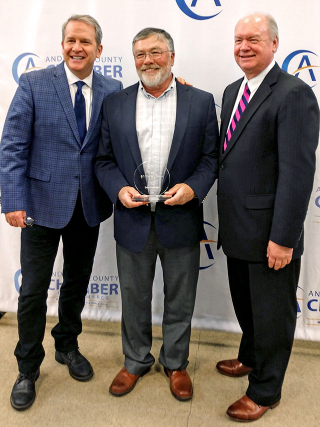 Ted Hall of WVLT, Gene Patterson of Consolidated Nuclear Security, LLC and Anderson County Chamber of Commerce President Rick Meredith photographed at the chamberâs annual business luncheon. Patterson was honored by the chamber with the R. C. Hoskins Award for his involvement in the Anderson County business community.