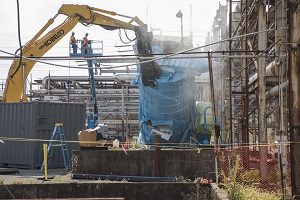 Crews demolish a Building 9201-05 (Alpha 5) dust collector tower at Y-12.