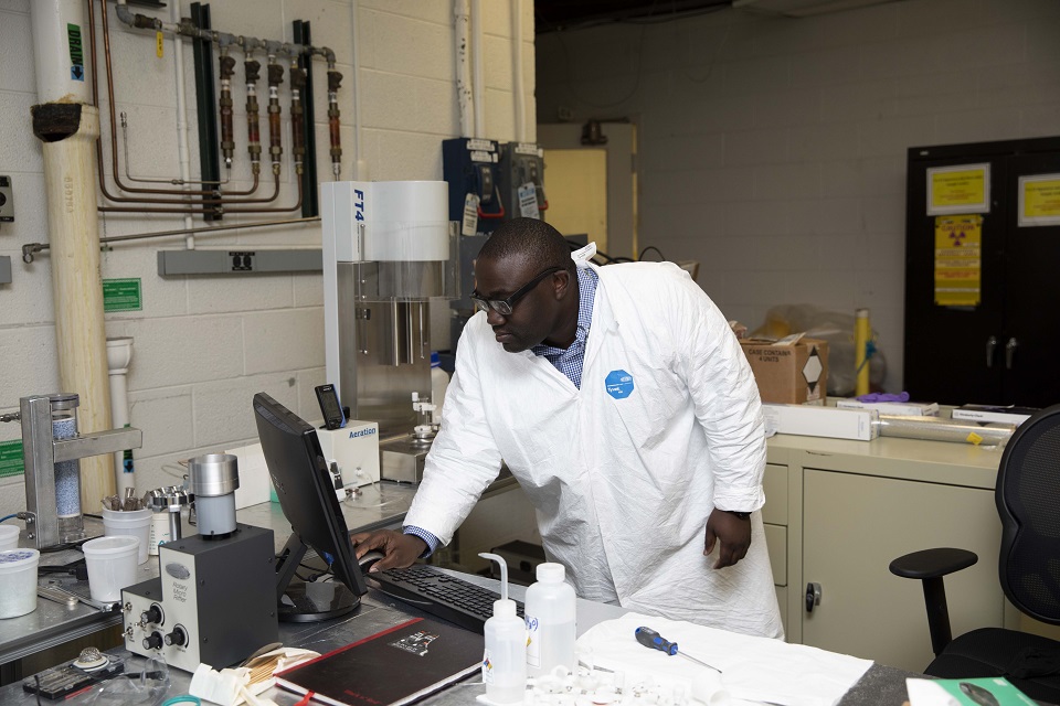 A Y-12 Mission Engineering intern works in a lab during his time at Y‑12.