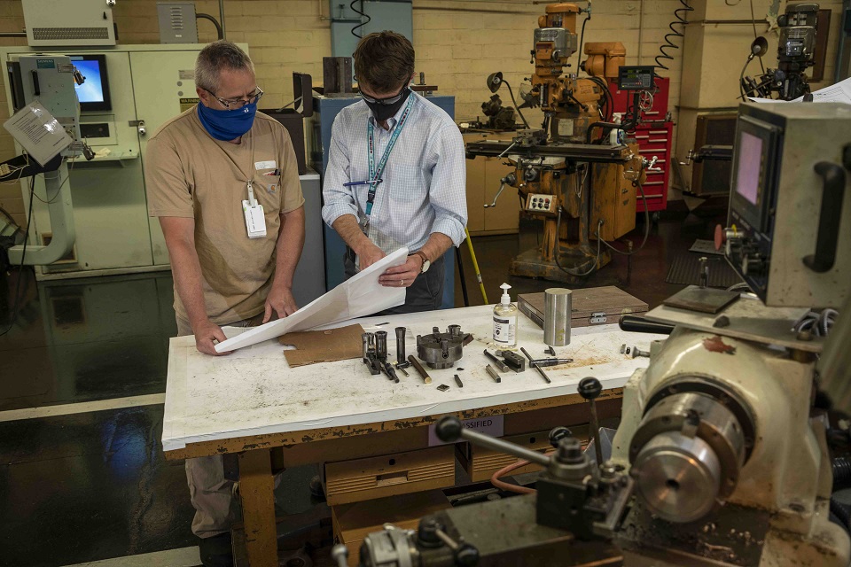 Machinist Randy Golliher, left, and Erik Swanson, GMO production support manager