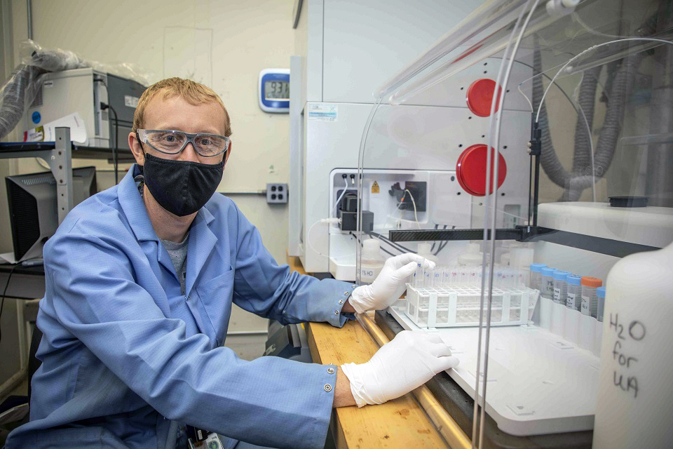 Worker analyzes samples on an inductively coupled plasma-mass spectrometry instrument.