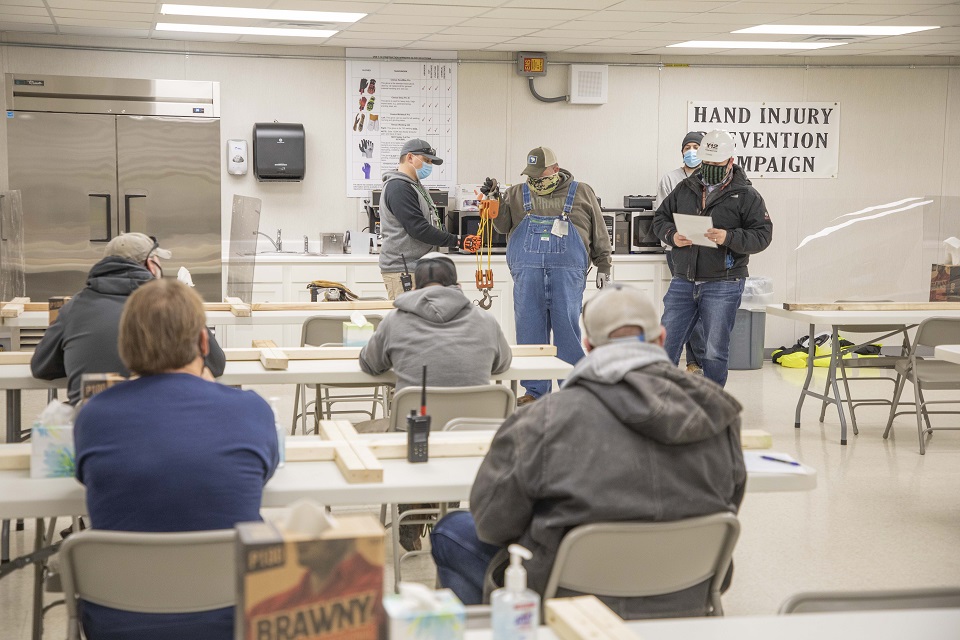 Workers watch an incident reenactment at Y-12 Construction as part of a recent Hand Injury Prevention Campaign