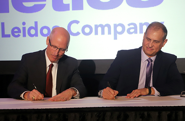 <em>Rich Tighe, president and <acronym title=”Chief Executive Officer”>CEO</acronym> of Consolidated Nuclear Security (left), and Jonathan Pettus, senior vice president of aerospace, civil and defense operations for the Dynetics Group at Leidos (right) sign a memorandum of understanding at the Tennessee Valley Corridor Summit in Huntsville, Alabama. The agreement will facilitate collaboration between the companies to support national security. </em> 