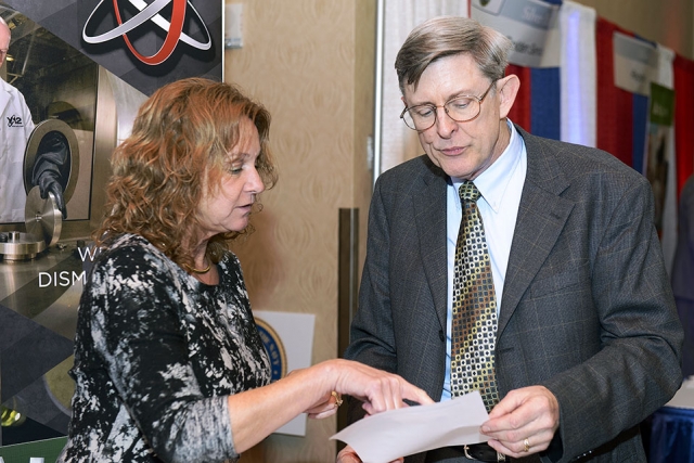 Elaine Najmola (left), who works with the Uranium Processing Facility Project, talks to a participant at the Tennessee Veterans Business Association Expo.