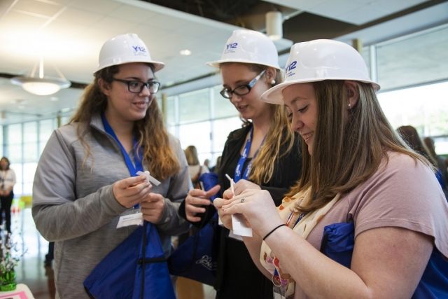 Martha Overbey, Katelynn Gregg, and Jessica Hulson from Campbell County High School learn about famous female engineers.