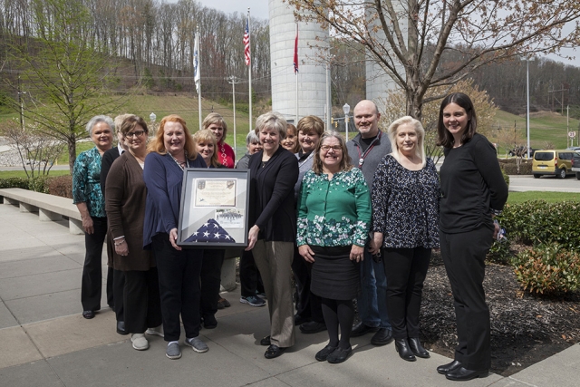 Communications staff members with the flag and certificate from the 39th Commuications Squadron in Turkey. 