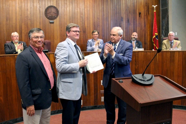 Gene Patterson and CNS Vice President and Y-12 Site Manager Bill Tindal accept an Oak Ridge City Council proclamation from Mayor Warren Gooch.