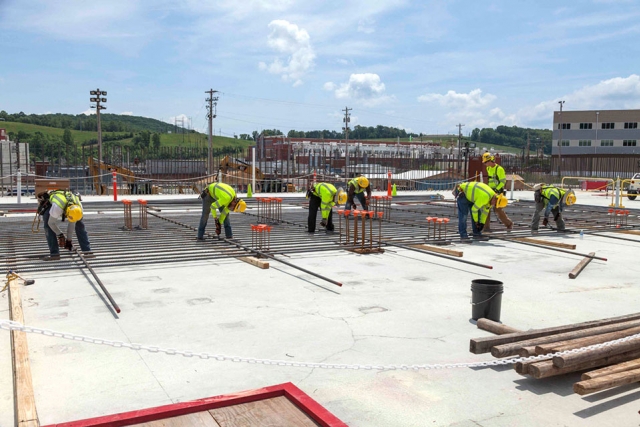 Skilled ironworkers position rebar for a wall curtain at the Main Process Building. 