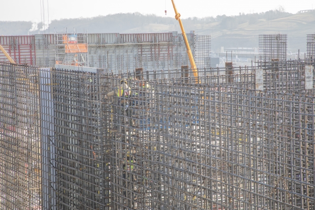 Two UPF ironworkers work together to tie rebar in place in preparation of the wall’s concrete placement at the Main Process Building.