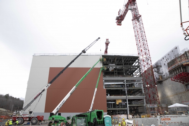 Crews install siding on the west side of the UPF Salvage and Accountability Building.