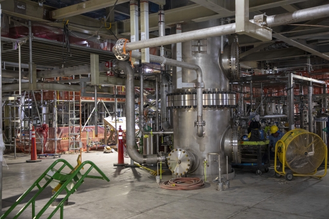 Pipefitters working tie-ins to the Salvage and Accountability Building POG Scrubber 