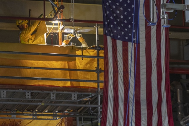 Ironworkers prep structural steel for pipe supports installation in the Main Process Building Main Casting Area 