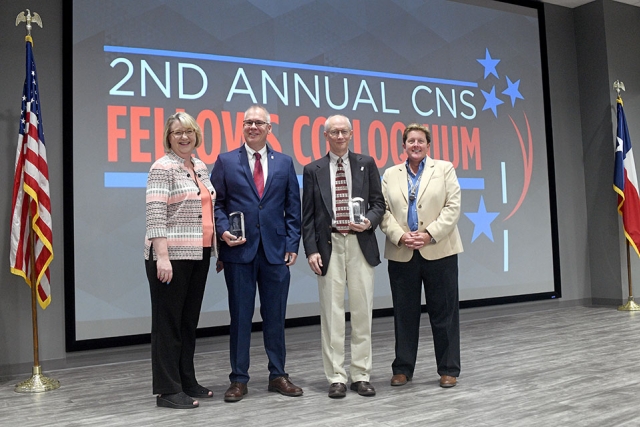Chief Operating Officer Michelle Reichert (left) and CNS Vice President Linda Bauer (right) congratulate the latest CNS Fellows: Neil Koone (left) and John Prazniak.