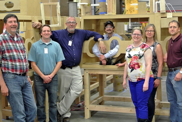 Project team members from Y‑12 and Merrick & Company during evaluation of the electrorefining glovebox mock‑up at the fabrication facility.