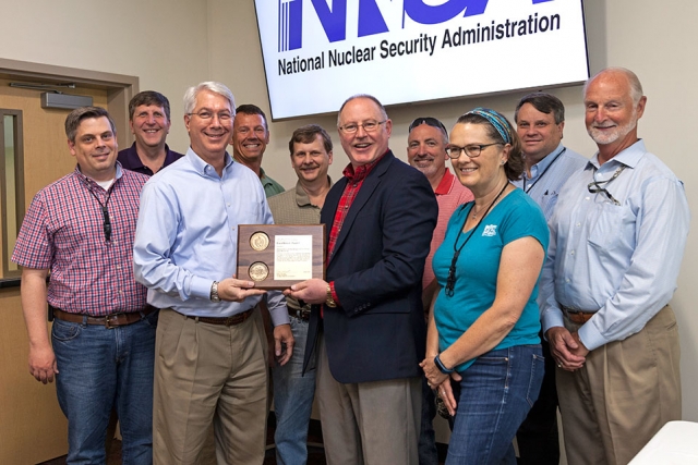 Members of the team who demolished Buildings 9111, 9112, and 9616-10 receive an Award of Excellence from Jim McConnell.