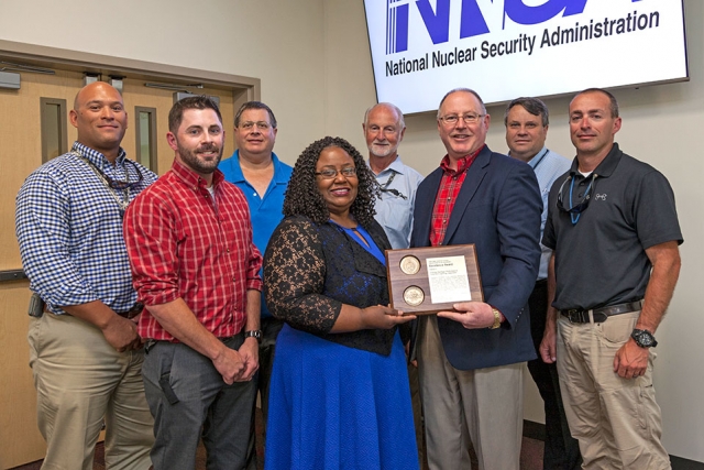 Members of the team that performed lighting upgrades for the Energy Savings Performance Contract receive an award from Jim McConnell, National Nuclear Security Administration’s Associate Administrator for Safety, Infrastructure and Operations.