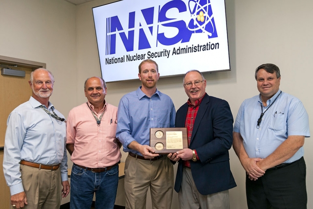 National Nuclear Security Administration’s Associate Administrator for Safety, Infrastructure and Operations Jim McConnell (second from right) presents an Award of Excellence for Construction Work Processes Improvements. 