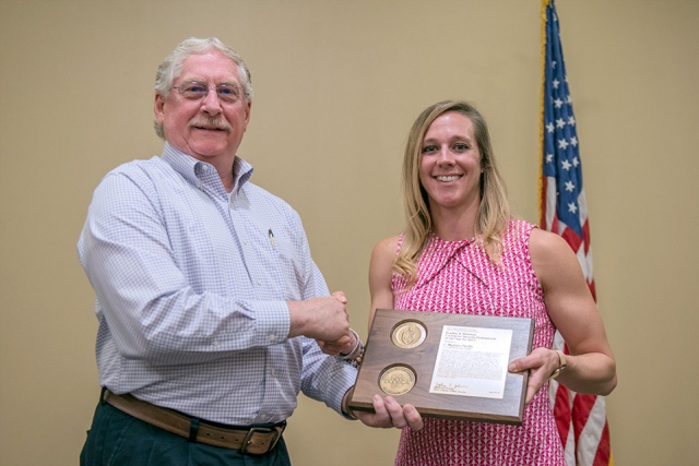 Meghann Parrilla accepts the NNSA Bradley A. Peterson Contractor Security Professional of the Year award from NNSA Deputy Associate Administrator for Defense Nuclear Security David B. McDarby at an awards ceremony at the Y-12 New Hope Center.