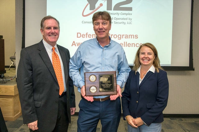 Y-12 Defense Programs employee Brian Gullett, center, accepts his team’s Award of Excellence from NNSA Assistant Deputy Administrator for Major Modernization Programs Michael Thompson and NNSA Production Office Deputy Manager Teresa Robbins.