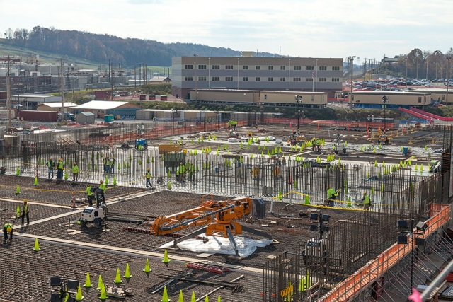 Rebar installation and concrete placement continue on UPF’s Main Process Building. The Construction Support Building in the background currently houses construction personnel.