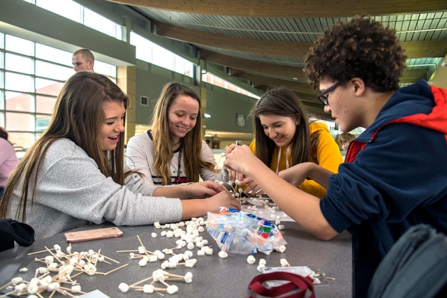 Oak Ridge High School students work together to assemble a tower out of toothpicks and marshmallows after being provided structurally sound designs options. The activity was one of three presented to students as part of Consolidated Nuclear Securityâs educational outreach during EWeek.