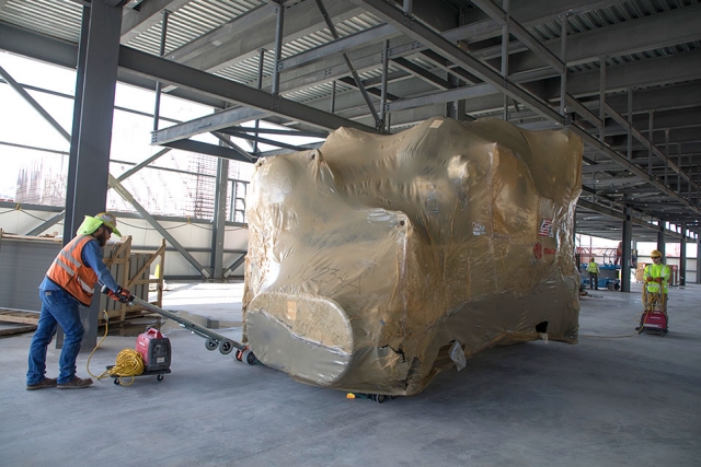 A chiller is placed inside the Mechanical Electrical Building at the Uranium Processing Facility March 15. The 49,000-pound piece of equipment was moved inside the building using a heavy duty electric dolly.