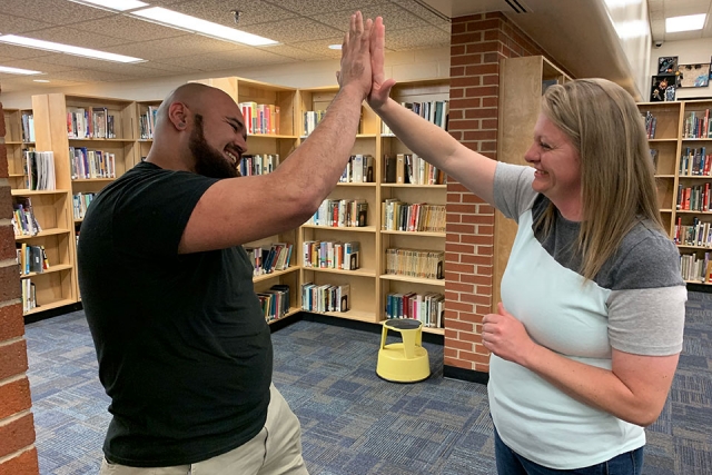 Gilbert Cruz, a Karns High School Career Technical Education teacher, high-fives Ashley Dawson, a machinist at the Y-12 National Security Complex. The two met at a recent teacher in-service at Powell High School where Y-12 members of the Atomic Trades and Labor Council discussed the benefits of a career in skilled crafts and trades and distributed information on local unions. “Ashley and I are in total agreement,” Cruz said. “There is another way to career success besides college. I teach my students that a