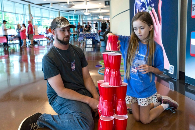 A father and daughter participate in some of the hands-on activities at Bring Your Children to Work Day. 