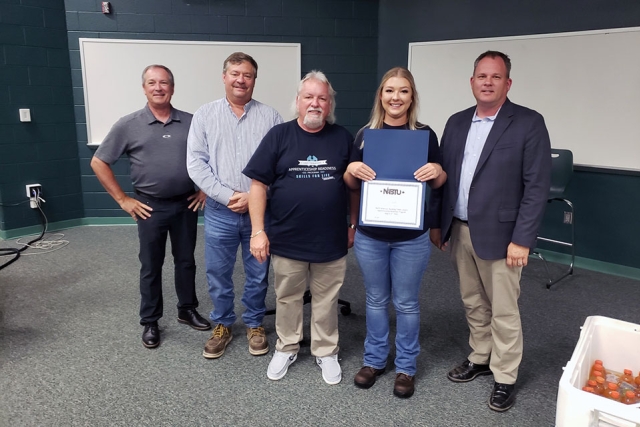 UPF Sheet Metal Apprentice Erin Scott (second from right) holds a certificate at the ETARP graduation ceremony. With her from left to right are: UCOR Labor Relations Manager Len Morgan, UPF General Superintendent John Arbaugh, East Tennessee Apprenticeship Readiness Coordinator Chris Branham, and UPF CNS Project Director John Platt II.