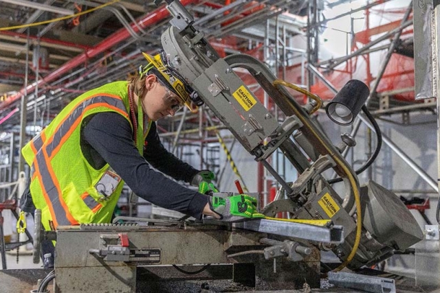 A member of the UPF Constuction team measures a support.