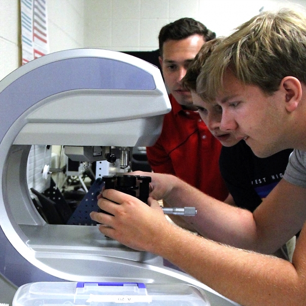 Materials Camp students use a hardness tester to compare the relative hardness of a control sample to an unknown heat-treated sample.